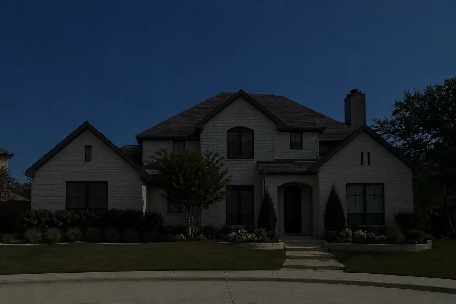 Two-story Fort Worth home before professional outdoor lighting installation at dusk.
